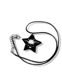 a star shaped necklace on a black background